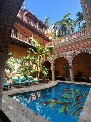 a swimming pool in the courtyard of a building at Casa Estrella Colonial Mansion in Cartagena de Indias