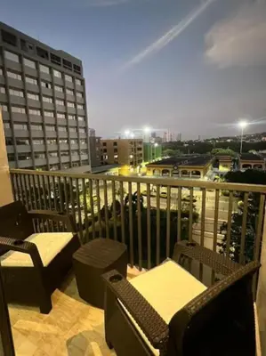 a balcony with chairs and a view of a city at Appartement neuf centre Cartagena la matuna in Cartagena de Indias