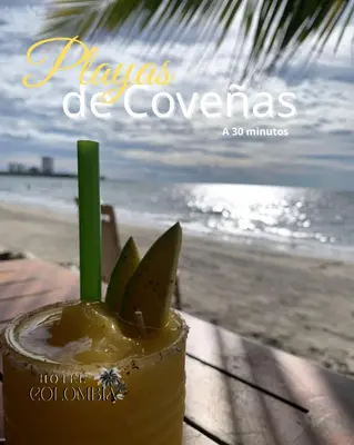 a drink sitting on a table next to the beach at Hotel Colombia Tolú in Tolú