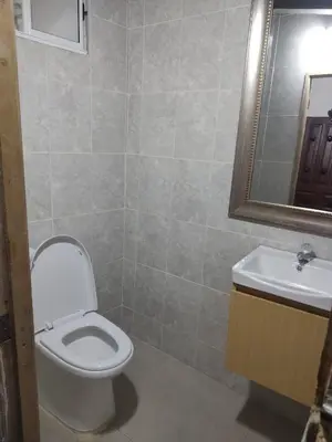a bathroom with a toilet and a sink and a mirror at Portalon de Magallanes apto para familias in Cartagena de Indias