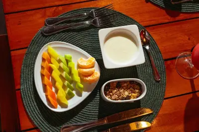a plate of food with fruit and other foods on a table at Pao Pao Cartagena in Isla Grande