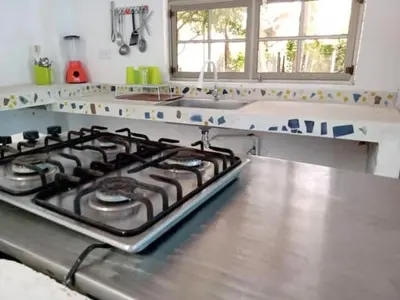 a kitchen with a stove top oven in a kitchen at San Jose de los Acuarios in San Antero