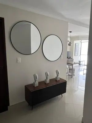 two mirrors on a white wall in a living room at Sleep by the Caribbean in Cartagena de Indias