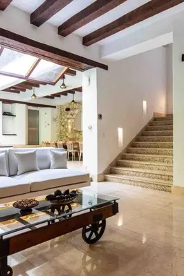 a living room with a white couch and stairs at Casa Gastelbondo in Cartagena de Indias