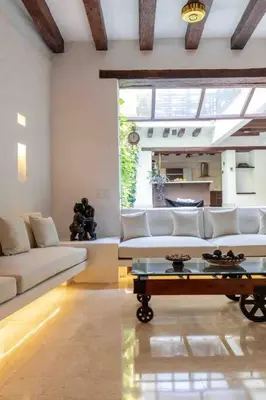 a living room with a white couch and a table at Casa Gastelbondo in Cartagena de Indias