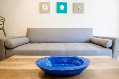 a blue bowl on a table in front of a couch at Santo Domingo - Centro Histórico in Cartagena de Indias