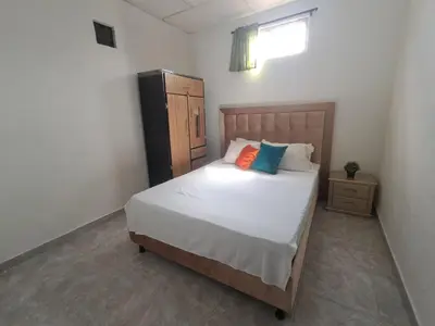 a bedroom with a bed with two pillows on it at LE REEVE, 3BR, Paz, Diseño Bohemio & Grupos in Cartagena de Indias