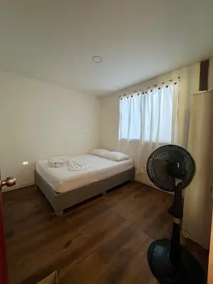 a small bedroom with a bed and a window at Roma apartamento in Playa Blanca