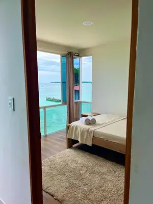 a bedroom with a bed and a view of the ocean at Roma apartamento in Playa Blanca
