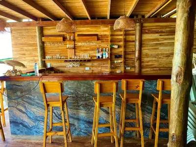 a bar with wooden stools in a restaurant at Roma apartamento in Playa Blanca