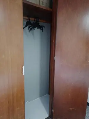 a closet with a glass door in a room at Confortable habitación en apartamento familiar en el Prado in Barranquilla