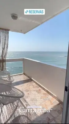 a balcony with a chair and a view of the ocean at Stylish & Renovated Condo in El Laguito, Cartagena in Cartagena de Indias