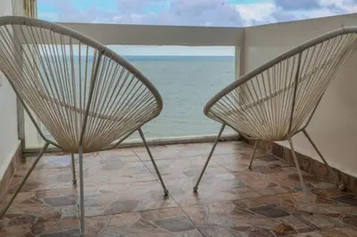 two chairs in a room with a view of the ocean at Stylish & Renovated Condo in El Laguito, Cartagena in Cartagena de Indias