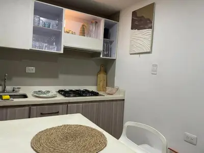 a kitchen with a stove and a counter top at Hermoso Apartamento cerca a la playa in Cartagena de Indias