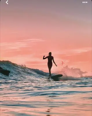 a man riding a wave on a surfboard in the ocean at Hermoso Apartamento cerca a la playa in Cartagena de Indias