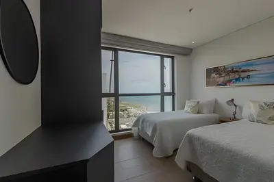 a bedroom with two beds and a large window at Awesome View Historic Center, Castle and Sea 2BR in Cartagena de Indias