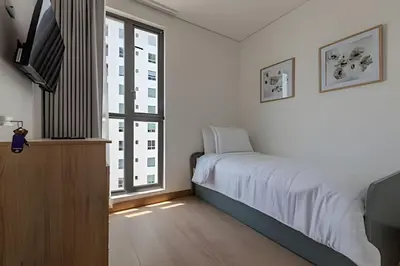 a bedroom with a bed and a large window at New Apt Beautiful Sea View and Walled City 2BR in Cartagena de Indias