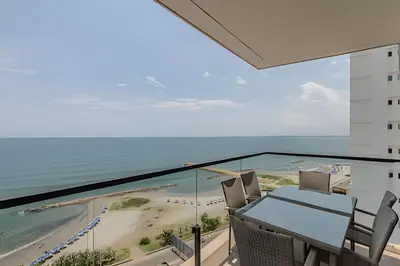 a dining room with a view of the ocean at New Apt Beautiful Sea View and Walled City 2BR in Cartagena de Indias