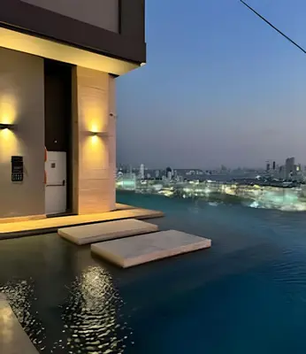 a pool with a view of the city at night at New Apt Beautiful Sea View and Walled City 2BR in Cartagena de Indias