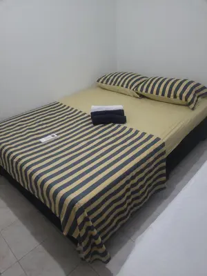 a bed with a black and white striped sheets and pillows at Casa rosymar in Cartagena de Indias