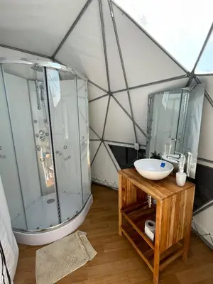 a bathroom with a shower and a sink in a tent at Hotel Aqua House in Tubará
