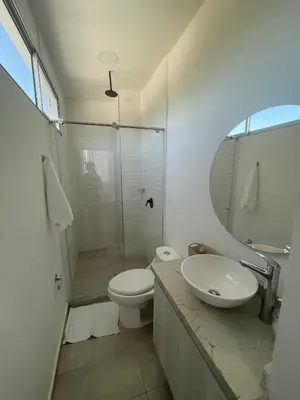 a bathroom with a toilet and a sink and a shower at Hotel Aqua House in Tubará