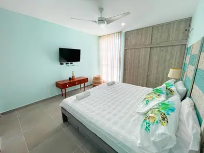 a bedroom with a large bed and a television at Magico Apartamento Frente al Mar 3 Habitaciones TR22 in Coveñas