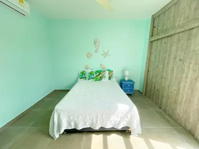 a bedroom with a bed in a blue room at Magico Apartamento Frente al Mar 3 Habitaciones TR22 in Coveñas