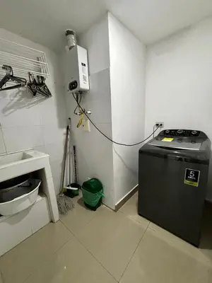 a kitchen with a washing machine in the corner of a room at Paraíso en Bocagrande con Vista al Mar in Cartagena de Indias