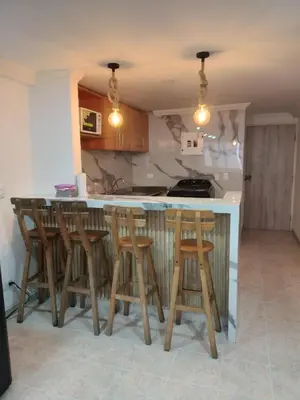 a kitchen with wooden stools at a kitchen counter at Apto espectacular frente al mar in Cartagena de Indias