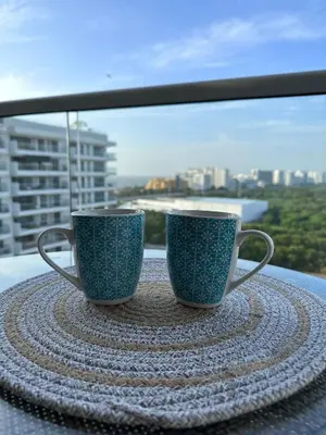 two coffee cups sitting on a table in front of a window at DQ1301 | 2H Jacuzzi privado + piscina infinita in Cartagena de Indias