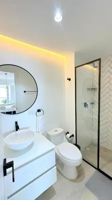 a white bathroom with a toilet and a sink at CB821 | Apartamento de lujo Vista al Mar Piscina in Cartagena de Indias