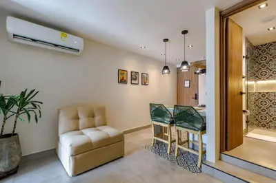 a living room with a chair and a table at De la cruz Studio Apartments in Cartagena de Indias