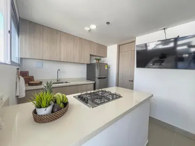 a kitchen with a stove and a counter top at Bocagrande Loft - Livin Colombia in Cartagena de Indias