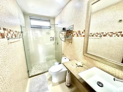 a bathroom with a toilet and a sink and a shower at by Calamari Homes - Altamar 30B1 near walled city in Cartagena de Indias