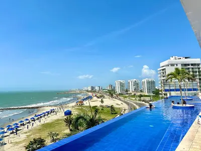 a view of the beach from the balcony of a resort at by Calamari Homes - Altamar 30B1 near walled city in Cartagena de Indias