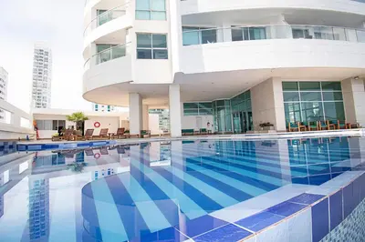 a swimming pool in front of a building at U-GO Palmetto Eliptic - Confort y Estilo en Cartagena in Cartagena de Indias
