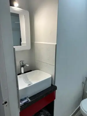 a bathroom with a white sink and a mirror at Tropical Caribean Apartment in Cartagena de Indias