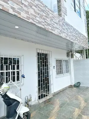 a scooter parked in front of a white building at Tropical Caribean Apartment in Cartagena de Indias