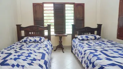two beds sitting next to each other in a room at Cabaña Villa Palmaral in Moñitos