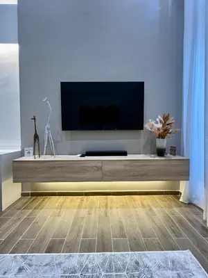 a living room with a flat screen tv on a entertainment center at Beautiful! Brand New Apt old town in Cartagena de Indias