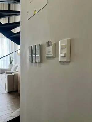 a living room with a white wall with books on it at Beautiful! Brand New Apt old town in Cartagena de Indias