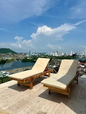 two lounge chairs on a roof with a view of a city at Beautiful! Brand New Apt old town in Cartagena de Indias