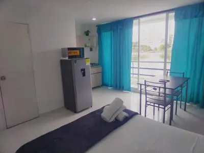 a room with a bed and a table and a kitchen at Marina del rey propiedades gaitan in Cartagena de Indias