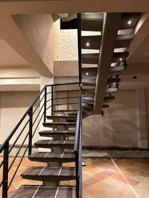 a staircase in a building with a metal railing at Santa Donama Paradise in Santa Marta