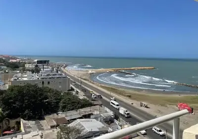 a view of a beach with cars on the road at Cabrero Beach 906 in Cartagena de Indias