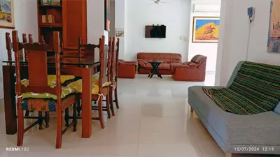 a living room with a table and chairs and a couch at TOLU ALOJAMIENTOS Oasis tropical elegante, relax, apartamento amoblado in San Silvestre