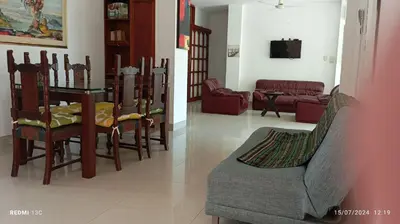 a dining room and living room with a table and chairs at TOLU ALOJAMIENTOS Oasis tropical elegante, relax, apartamento amoblado in San Silvestre