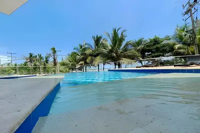 a swimming pool with blue water and palm trees at 2 dormitorios Morros. Vistas y salida playa in Cartagena de Indias