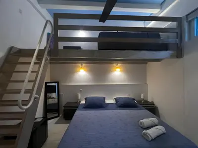 a bedroom with a bed with blue sheets and a staircase at Casa Lazuli 303 Cartagena in Cartagena de Indias